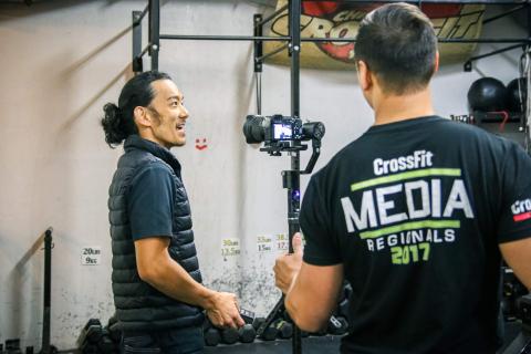coach Otoya smiles while being filmed by CrossFit Media